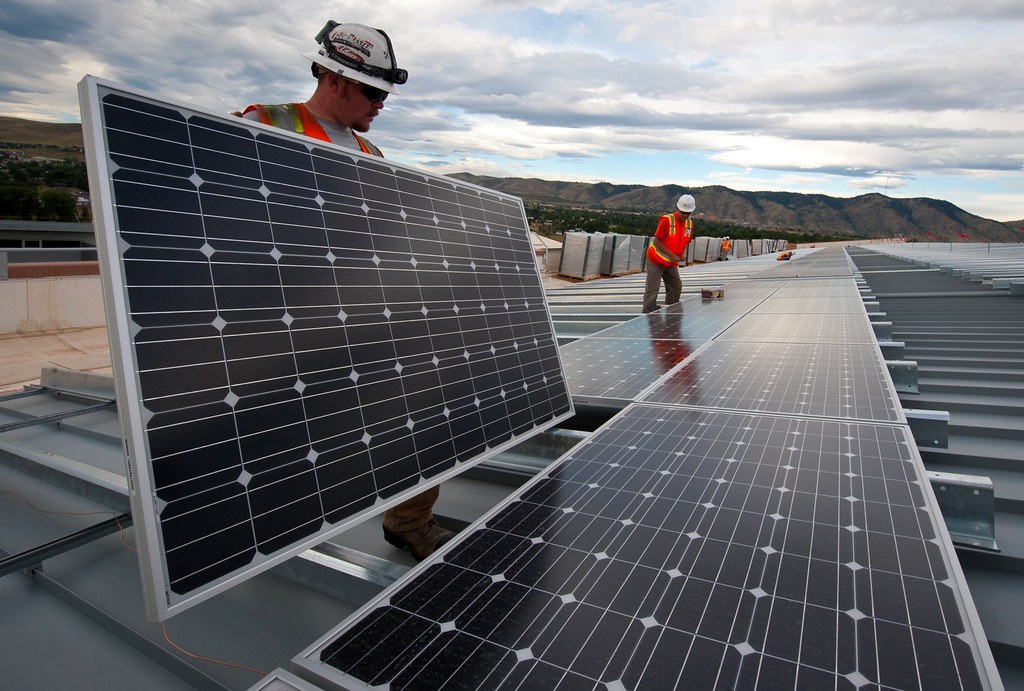 Solar project team coordinating rooftop system layout in the field